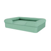 Een bolster hondenbed in groenblauw.
