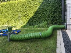 Een groene tunnel die twee behuizingen verbindt