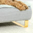 Close up van hond zittend op Omlet Topology hondenbed met bolster bed topper en Gold rail voeten
