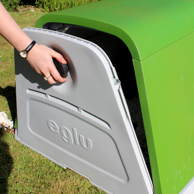 Opening the back door of the Eglu Go Rabbit Hutch